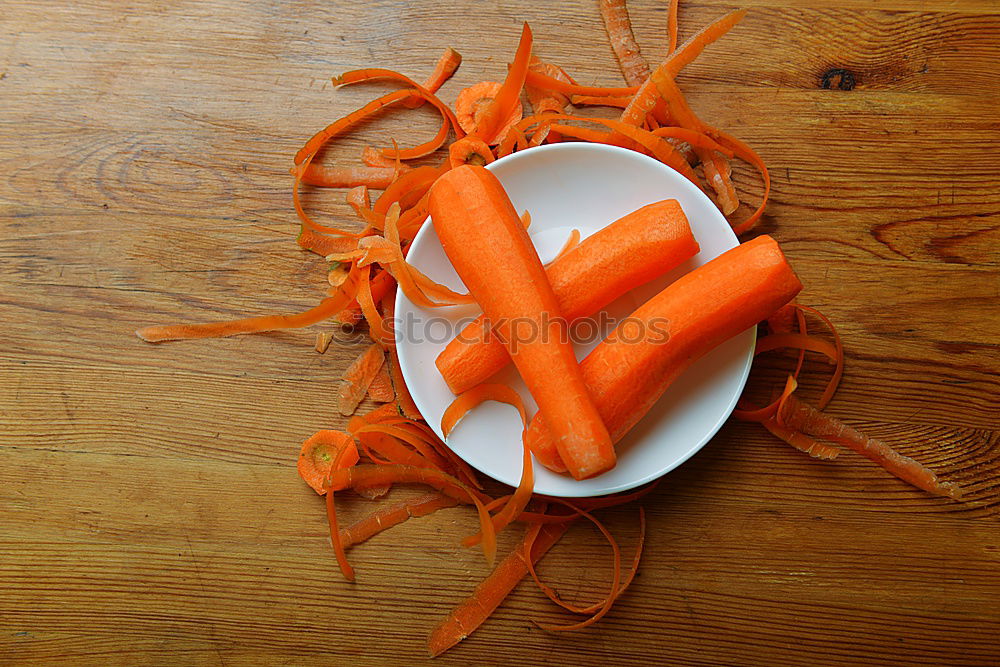 Similar – female human hand holding three large orange carrot