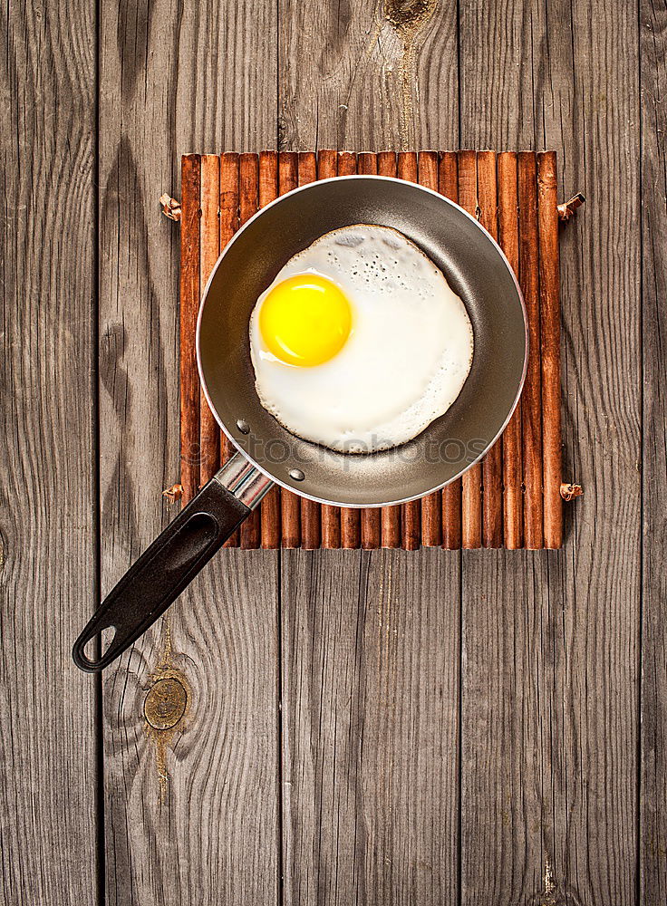 Similar – Fried egg in a old frying pan