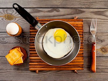 Similar – Fried egg in a old frying pan