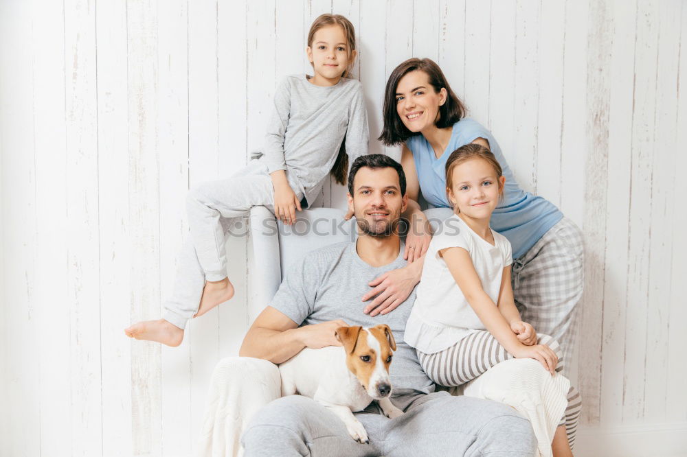 Similar – Mature couple relaxed at home in bed with their four little daughters and the Dog