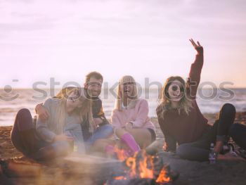 Multicultural group of young adult friends talking to each other