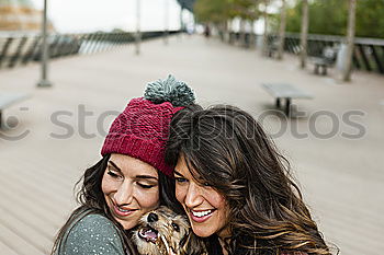 Similar – Two happy friends or sisters sitting and smiling