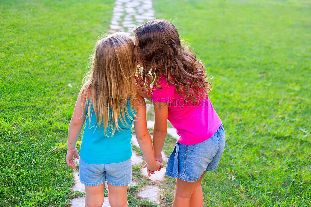 Similar – Two happy children playing near a tree on the grass