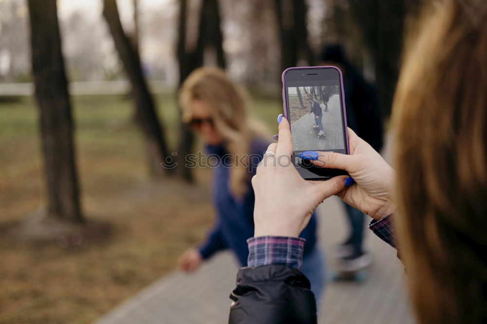 Similar – Image, Stock Photo Young woman is holding smartphone in her hands at the beach