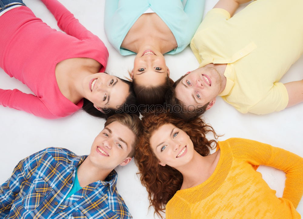 Similar – Women and men laying on grass wearing casual clothes.