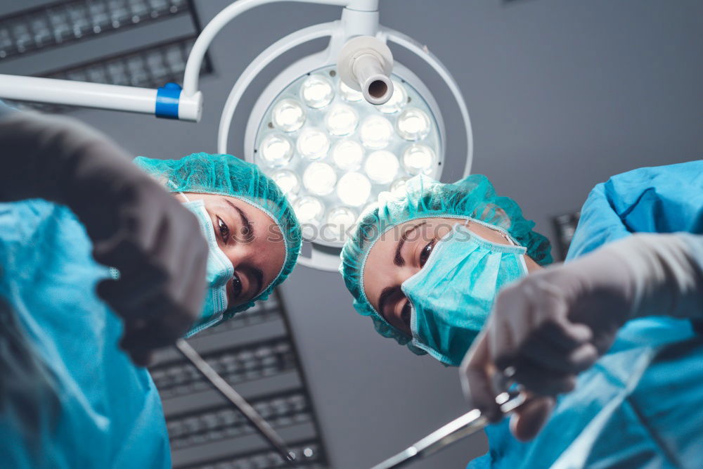 Similar – Image, Stock Photo Team of Surgeons Operating.