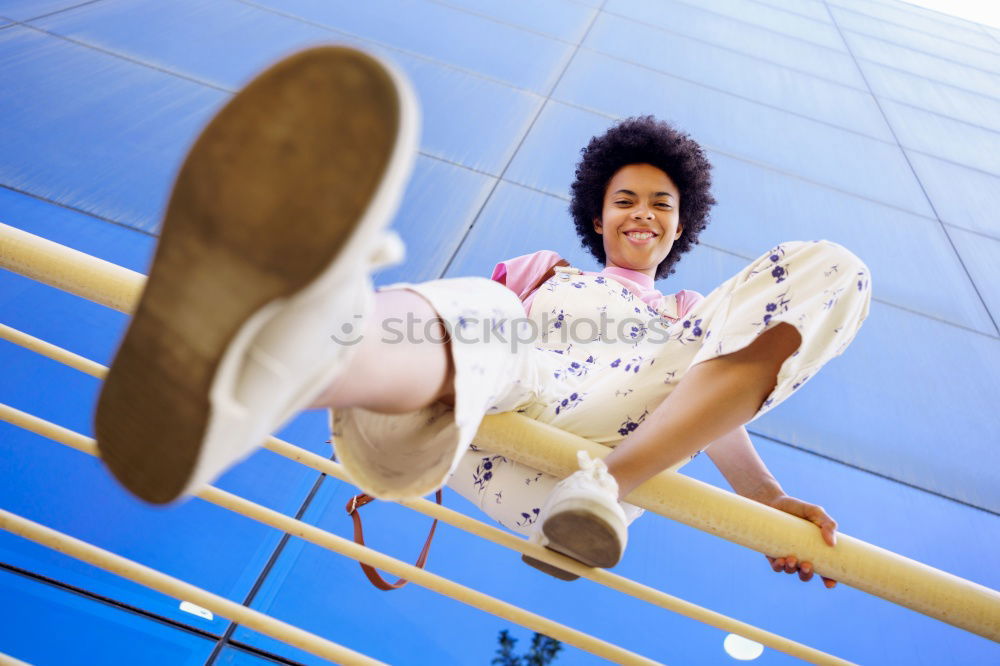 Similar – Woman with afro hair climbing by children’s attractions.