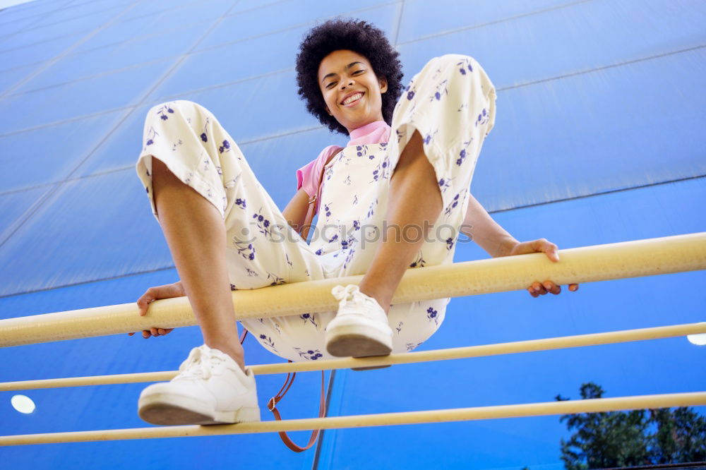 Similar – Woman with afro hair climbing by children’s attractions.