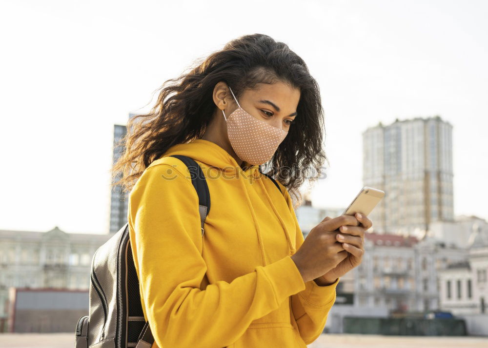 Similar – Happy woman with hat in city street, while using technology