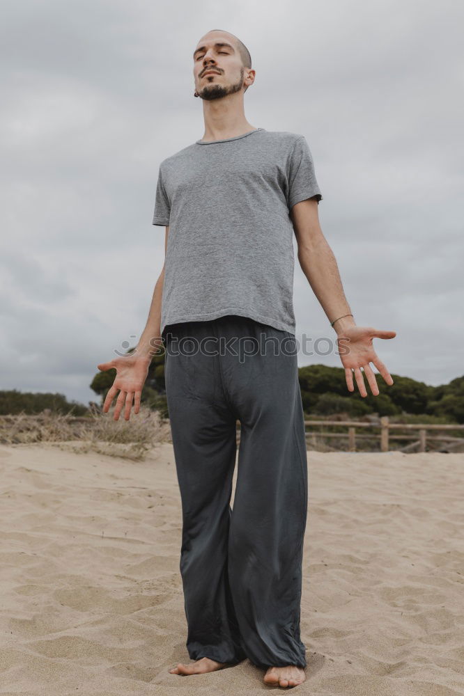 Similar – Young sports man is doing yoga for preparation of his workout