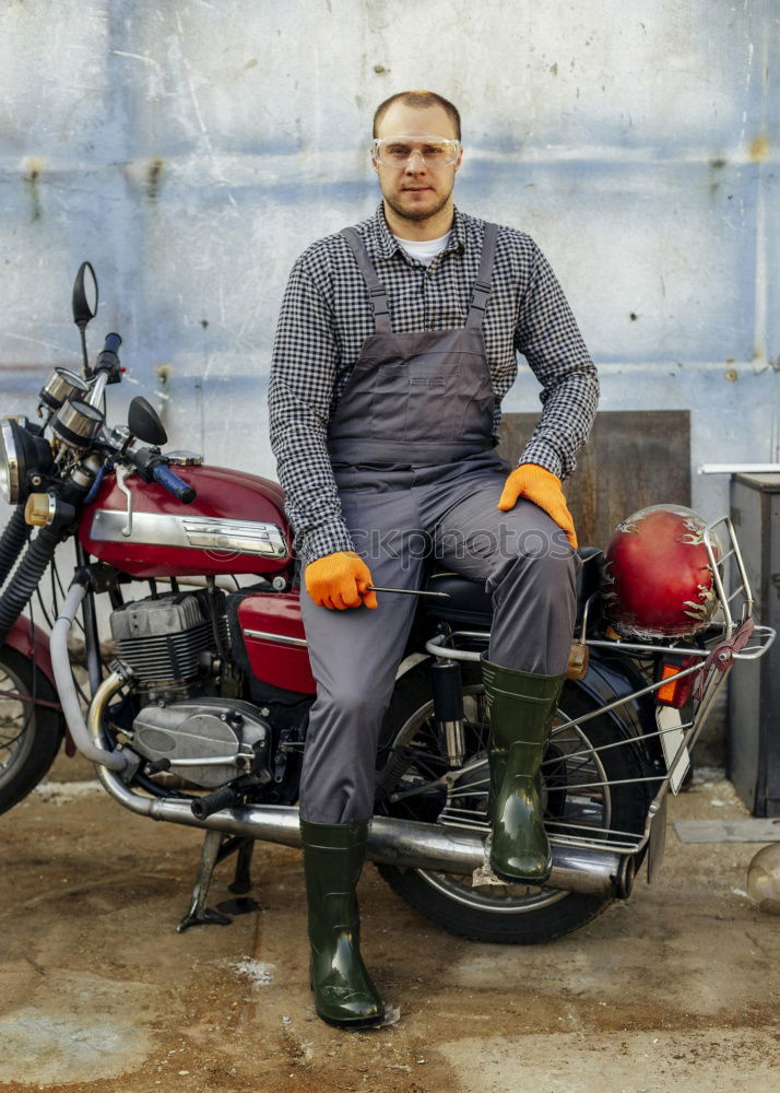 Similar – Man on bike at garage