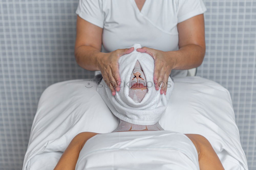 Massage therapist doing lymphatic drainage treatment to woman