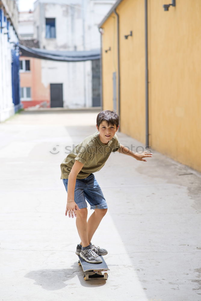 Similar – Kid skateboarder doing a skateboard trick.