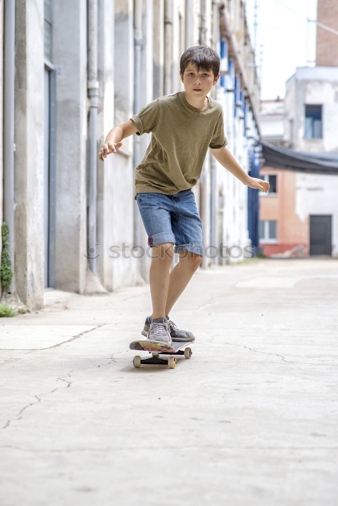 Similar – Kid skateboarder doing a skateboard trick.