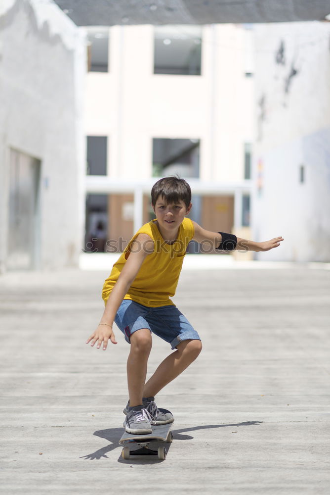 Similar – Kid skateboarder doing a skateboard trick.