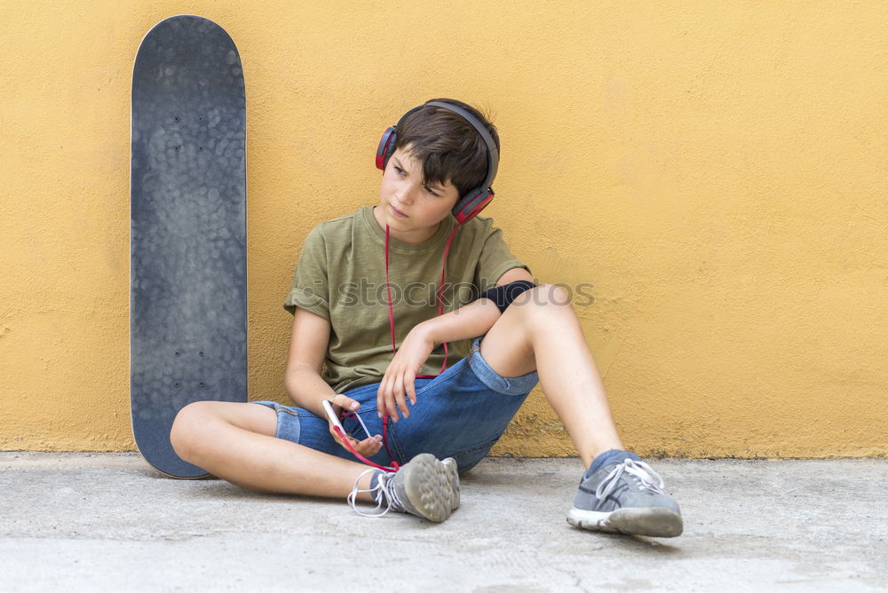 Image, Stock Photo A smiling boy with skateboard sitting alone on the floor