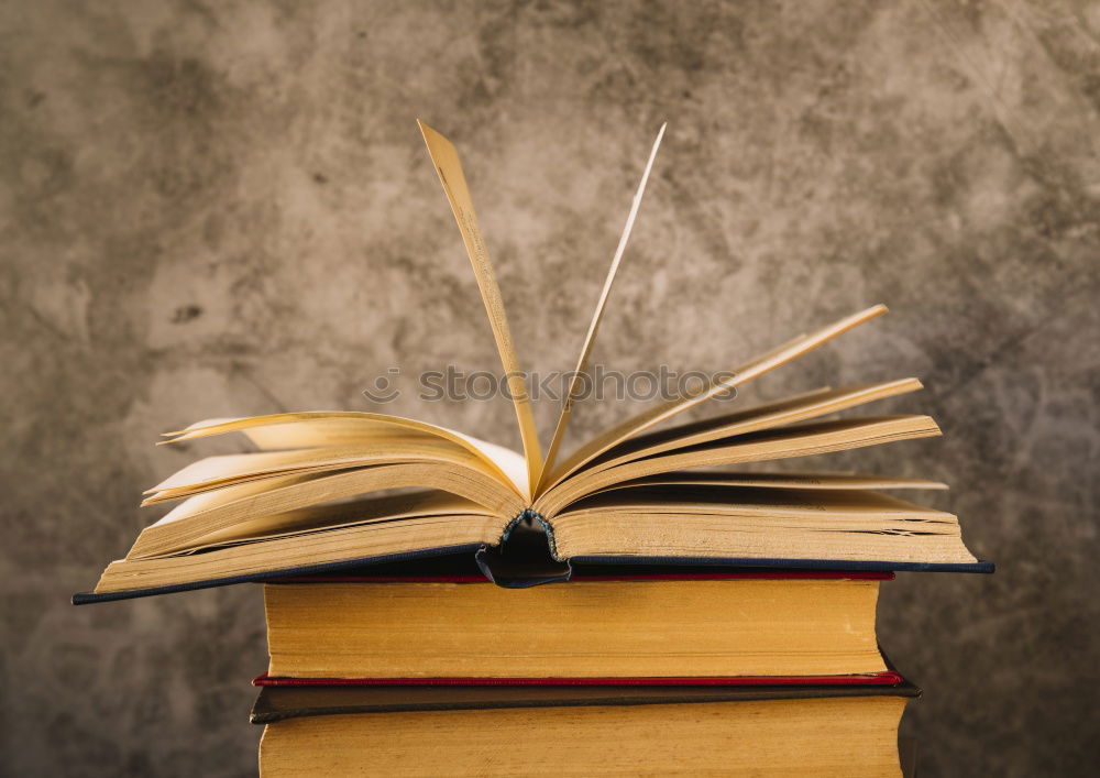 Similar – Woman turning pages of book on table in antique bookstore