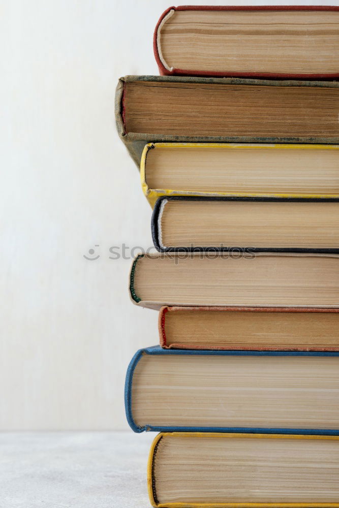 Similar – Woman turning pages of book on table in antique bookstore