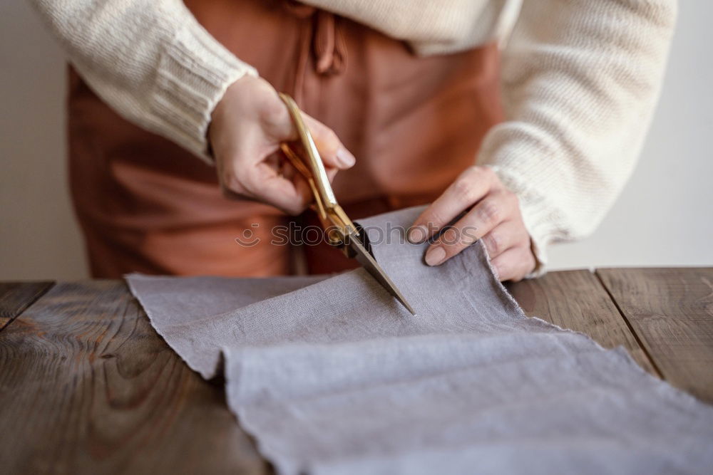 Similar – Women sew on sewing machine