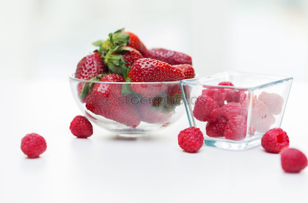 Similar – Berry-fruity water, iced with raspberries, blueberries, ice cubes and drinking straw on white background