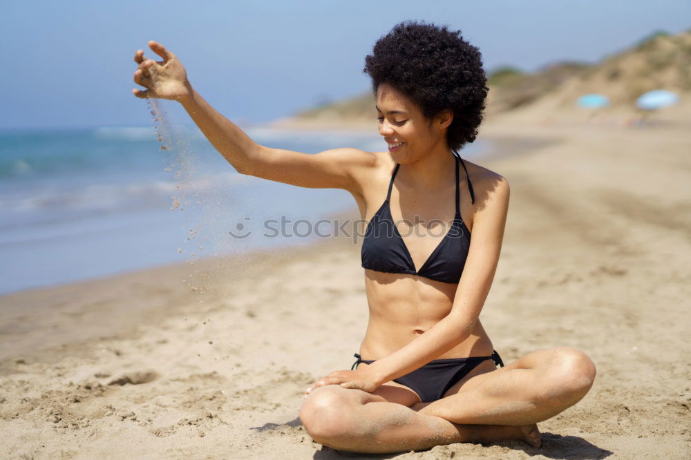 Similar – Beautiful young woman posing on the sand in a desert dunes