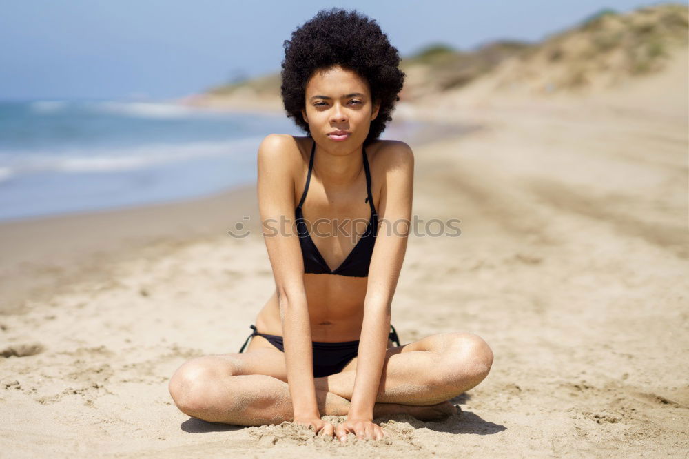 Similar – Woman with afro hairstyle sitting on a bench moving her legs