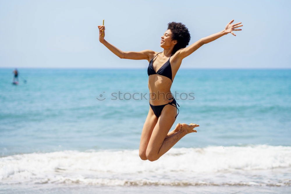 Similar – Young woman in bikini on a tropical beach with open arms.