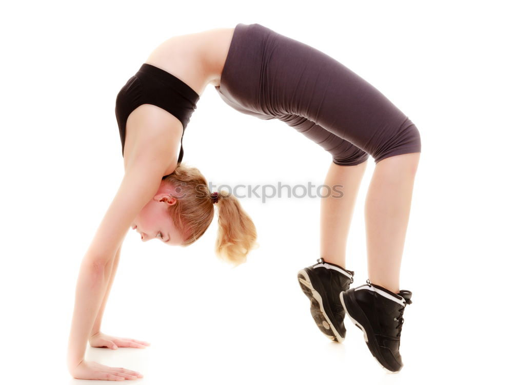 Similar – Woman stretching her body in front of ancient wall in park