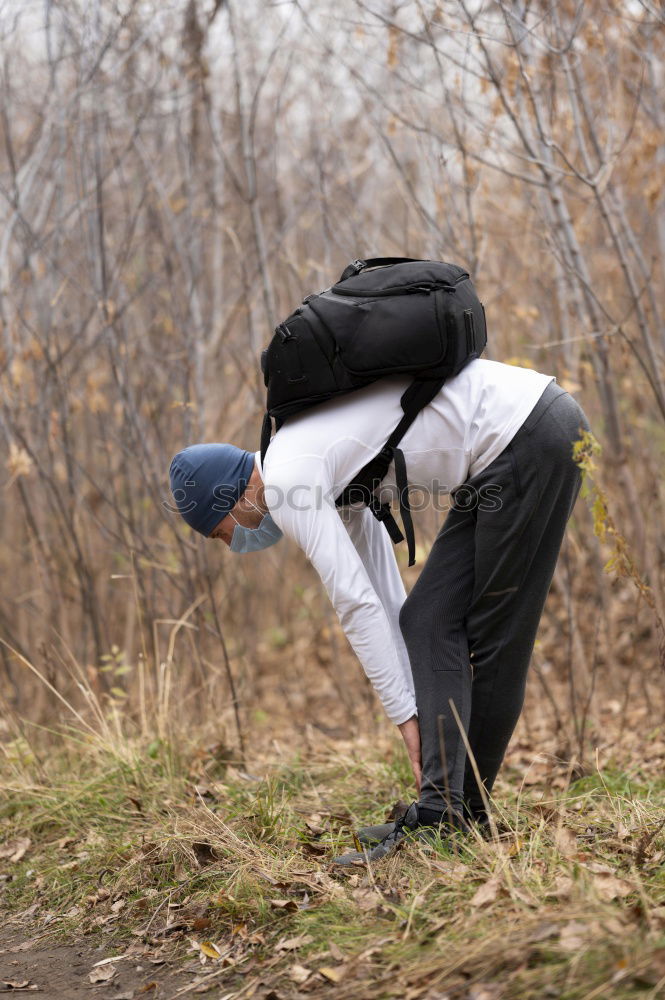 Image, Stock Photo Woman stretching her body in front of ancient wall in park