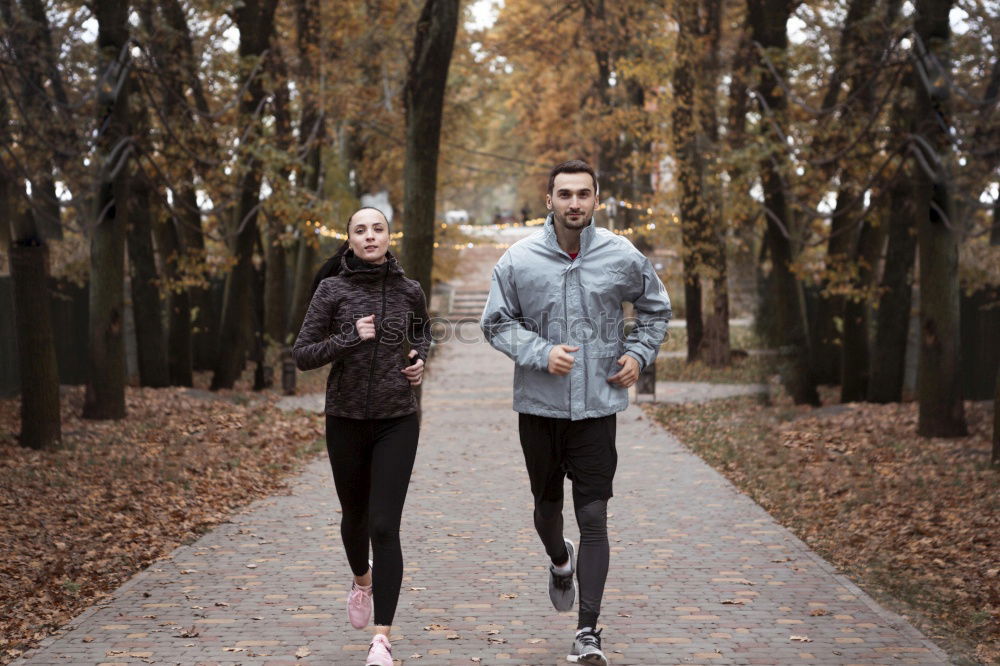 Similar – Active young couple jogging in an urban street