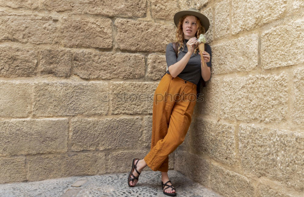 Similar – Portrait of young adult female in front of yellow wall