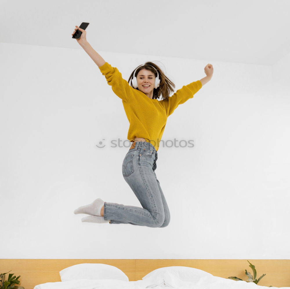 Similar – Long haired girl in jeans jumps headfirst into a sofa