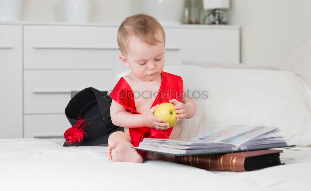 Similar – Image, Stock Photo Little kid on Christmas day on the bed with a gift