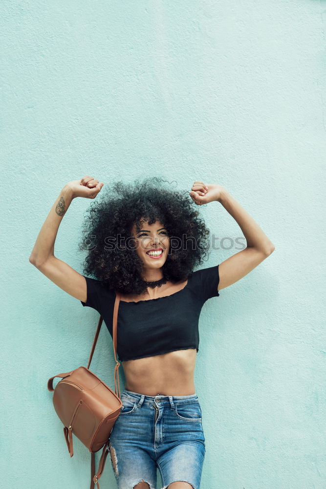 Image, Stock Photo Funny black woman with afro hair raising arms outdoors