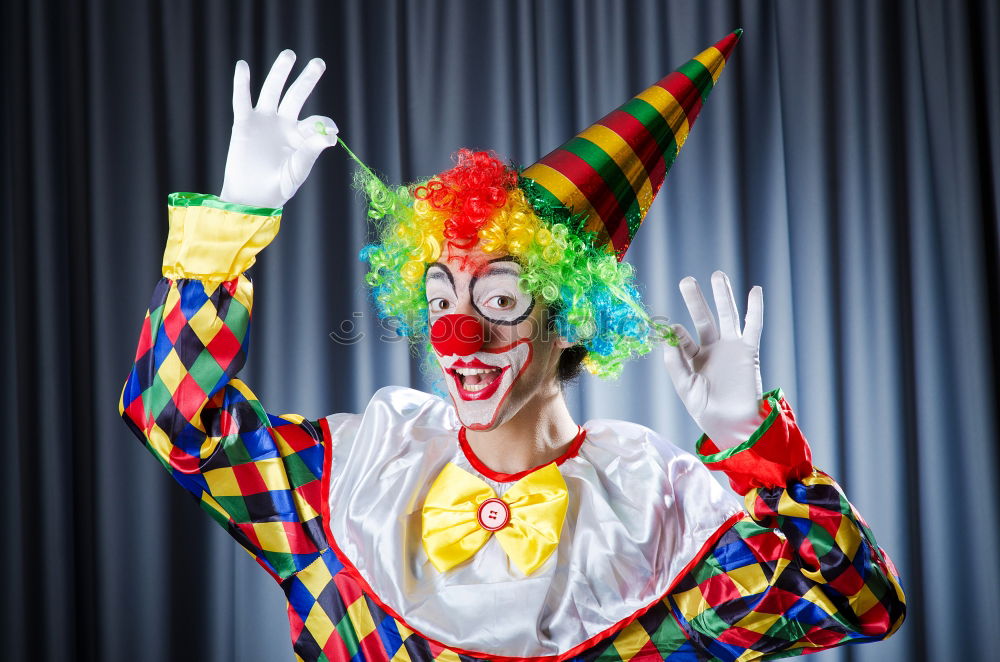 Similar – boy dressed as a clown on black background