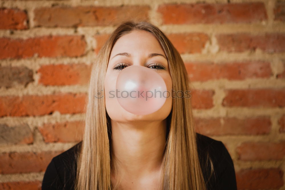 Similar – Image, Stock Photo Young blonde woman making a chewing gum bubble