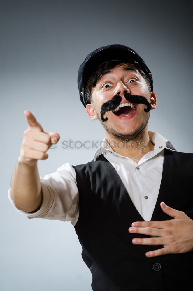 Similar – Young man vaping, studio shot. Bearded guy with sunglasses blowing a cloud of smoke on black background. Concept of smoking and steam without nicotine.