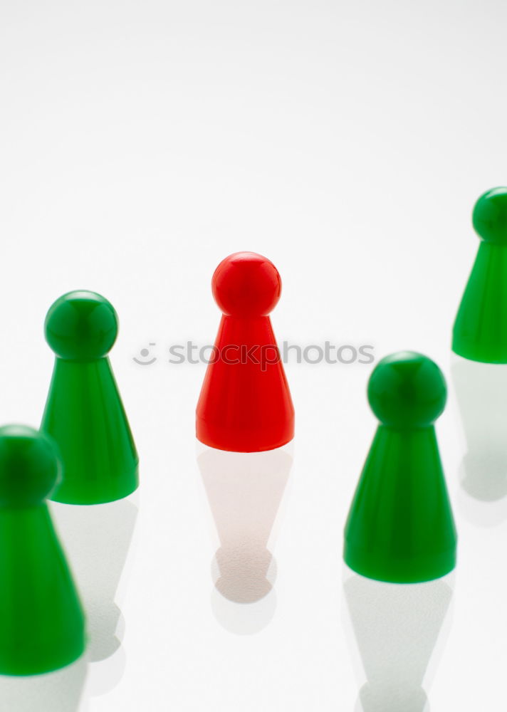 Similar – Three game pieces in German colours stand in front of a large group of game pieces in black, red, gold