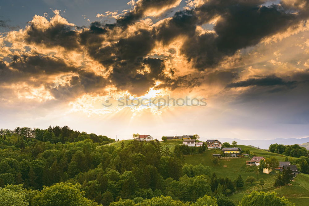 Similar – Fields and buildings in the mist at sunset.