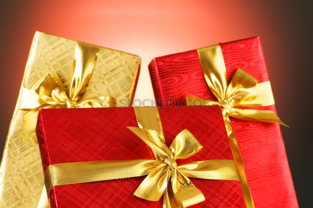 Christmas gifts presents on red glitter background. Copyspace