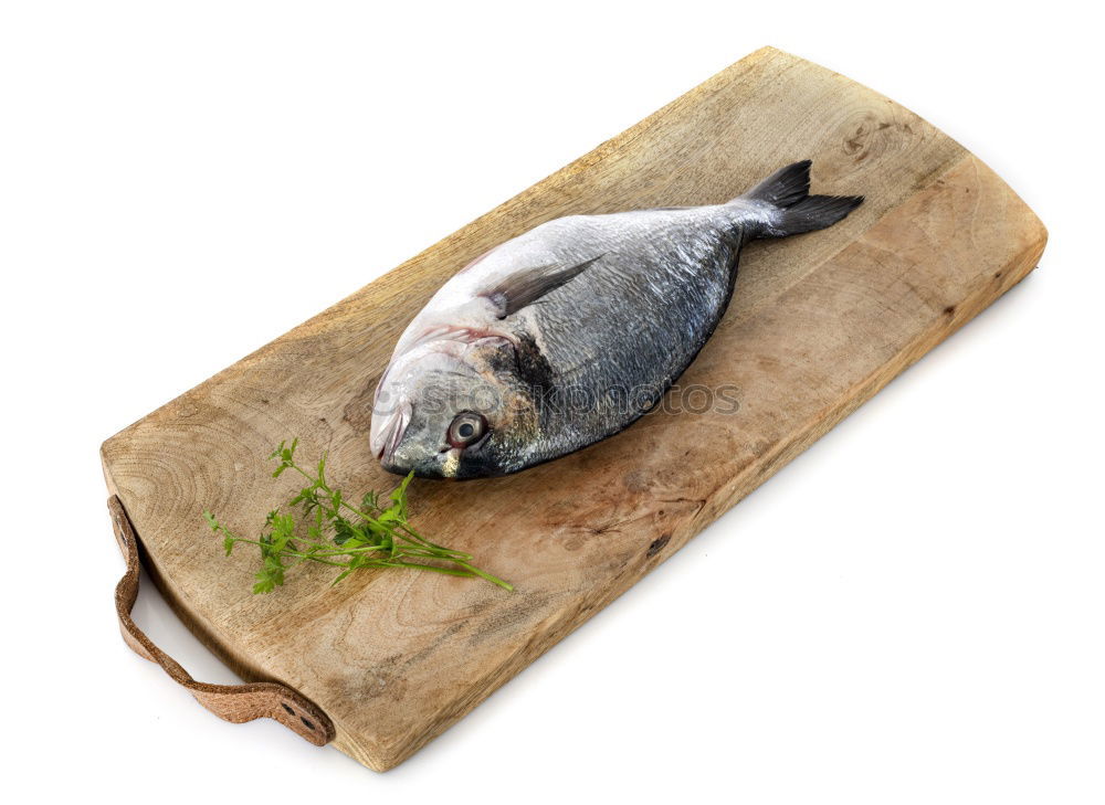 Similar – Image, Stock Photo Sea bass on kitchen table with lemon and rosemary