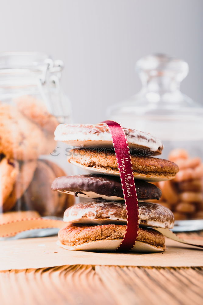 Gingerbread cookies in jars on wooden table