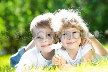 Similar – Two happy children playing near a tree on the grass