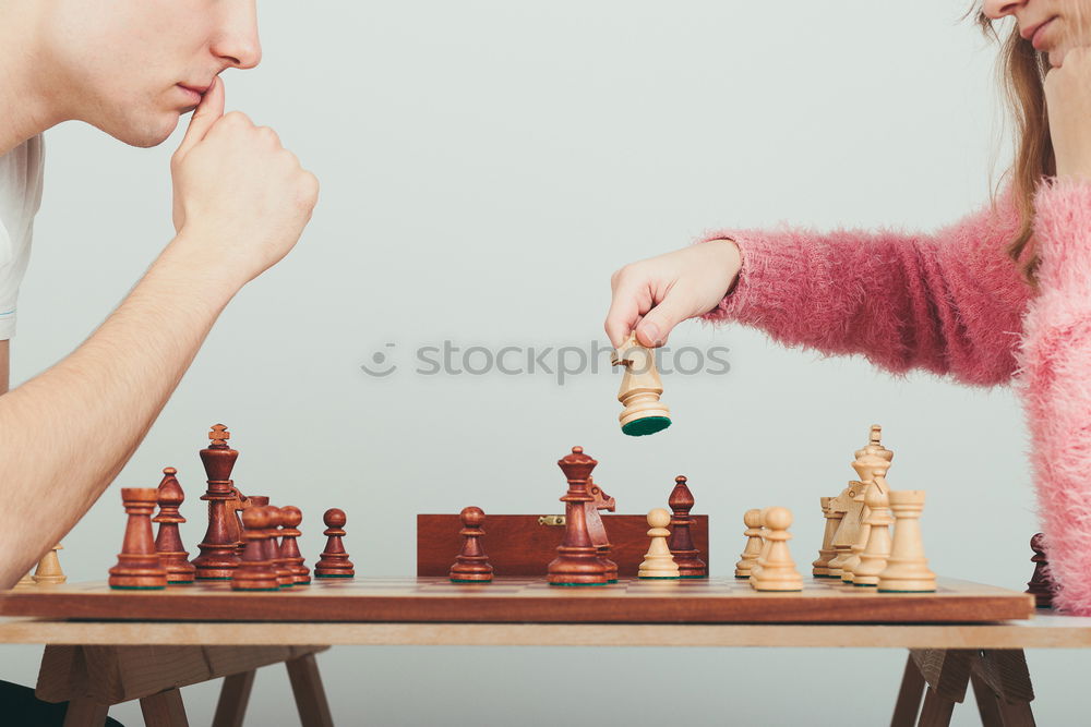 Similar – Girl and boy playing chess at home.