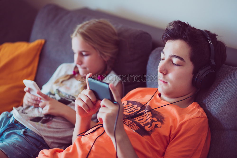 Similar – Image, Stock Photo Top shot of brother and sister listening to music together from smartphones