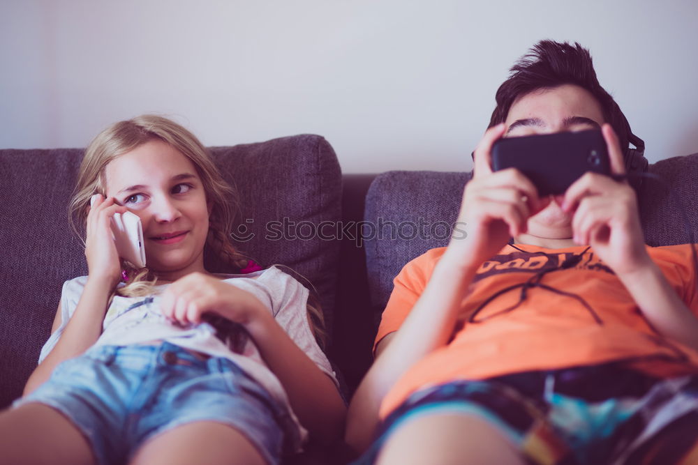 Similar – Image, Stock Photo Young women using mobile phones watching music clip, texting, messaging. Teenagers using the smartphones, sitting on sofa at home. Using technology devices. Girls wearing summer clothing