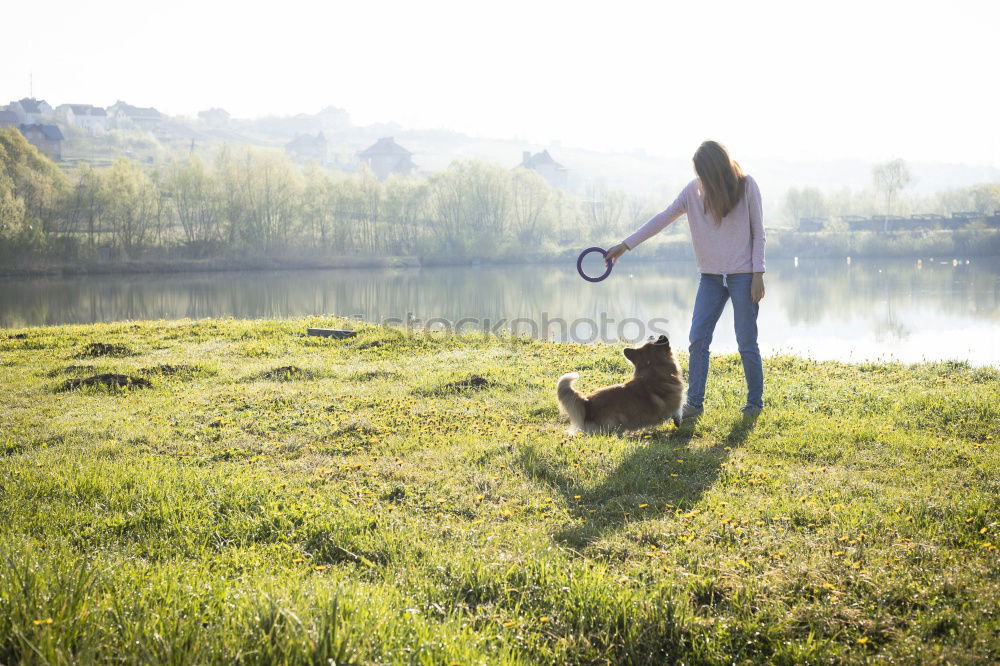 Similar – happy child girl walking country road with her dog