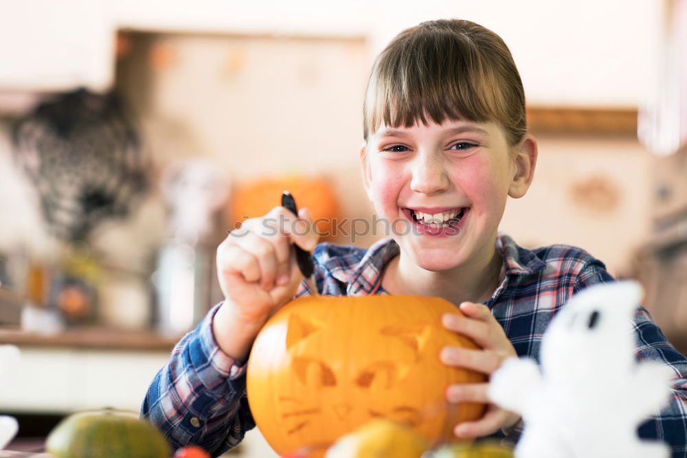 Similar – Image, Stock Photo Little girl holding a pumpkin in her hands, on Halloween.