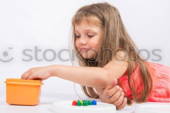 Similar – Girl decorating Christmas gingerbread cookies with chocolate