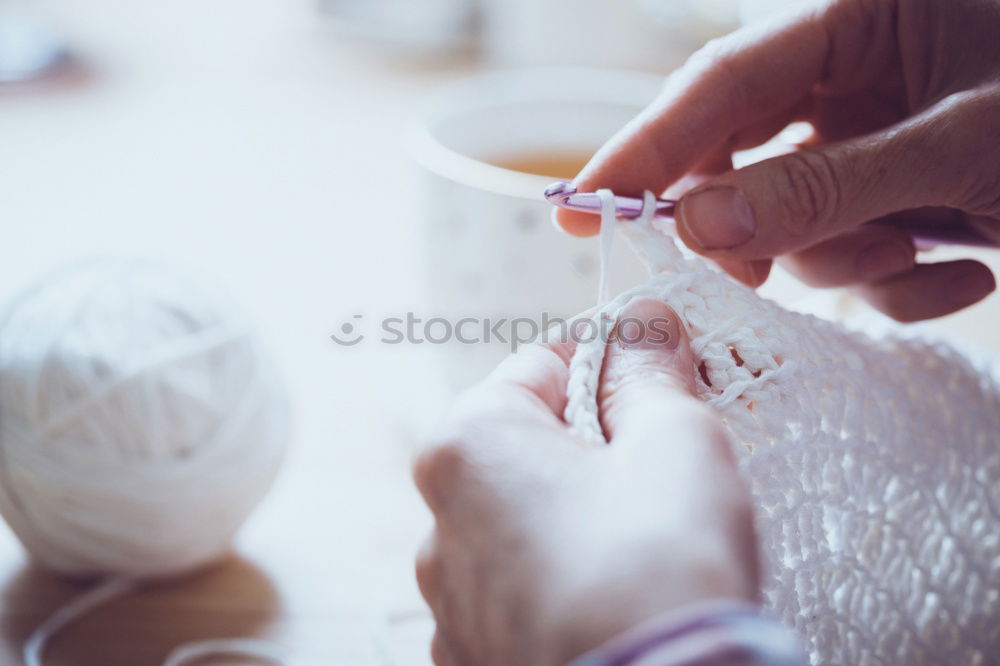 Similar – Close up on woman’s hands sewing needle and thread. Old woman working wasted hands .Tailor sewing some fabric. Details, low light, moody